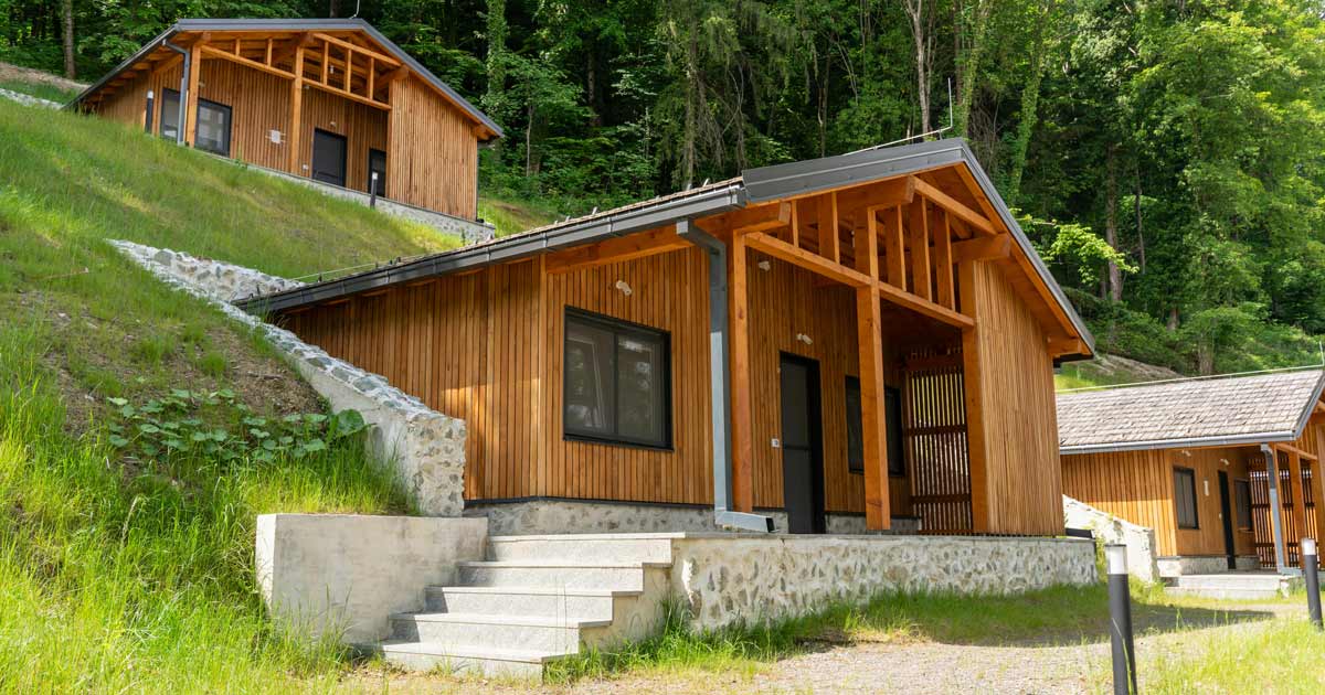 Wooded hillside camp cabins at a summer camp facility available for group rental