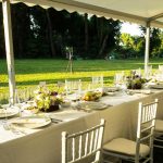 Outdoor dining tent set for a group meal at a summer camp family reunion