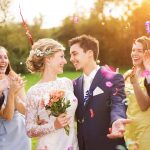 Wedding celebration with couple and guests outdoors at a summer camp venue
