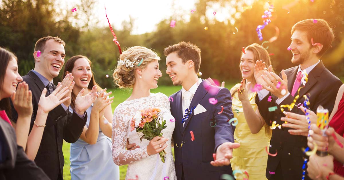 Wedding celebration with couple and guests outdoors at a summer camp venue