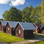 Row of summer camp cabins at a facility available for group rental pricing