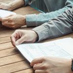 Group planner reviewing a summer camp rental agreement before signing
