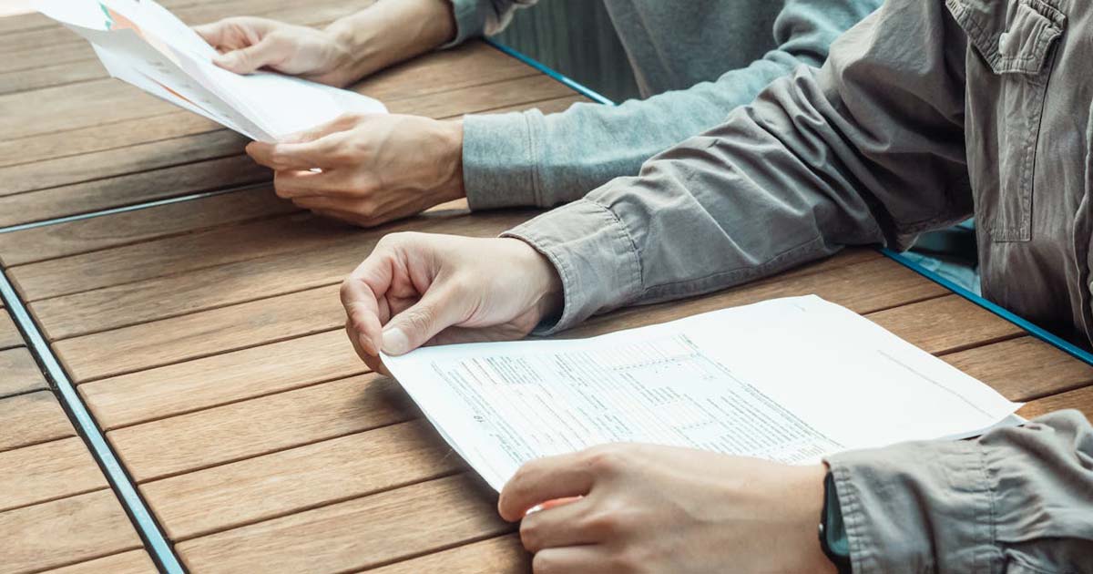 Group planner reviewing a summer camp rental agreement before signing