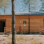 Wooded summer camp bathhouse with a ramp at each entrance